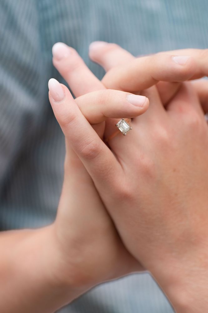 Close-up of hands with an engagement ring