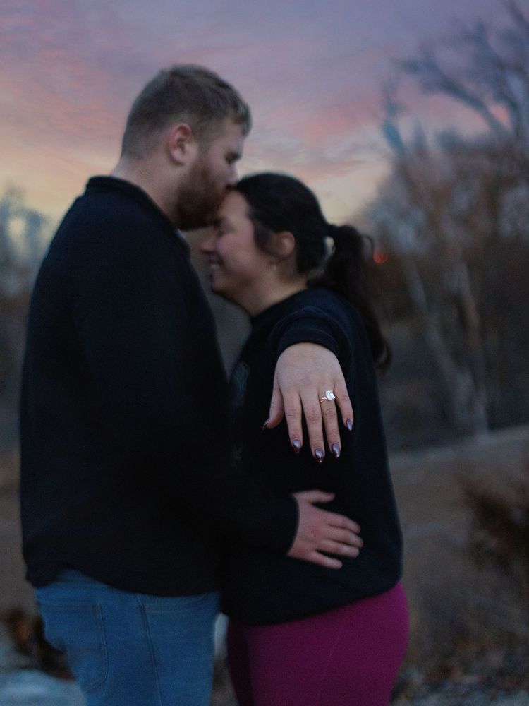 Couple embracing at dusk, ring on show