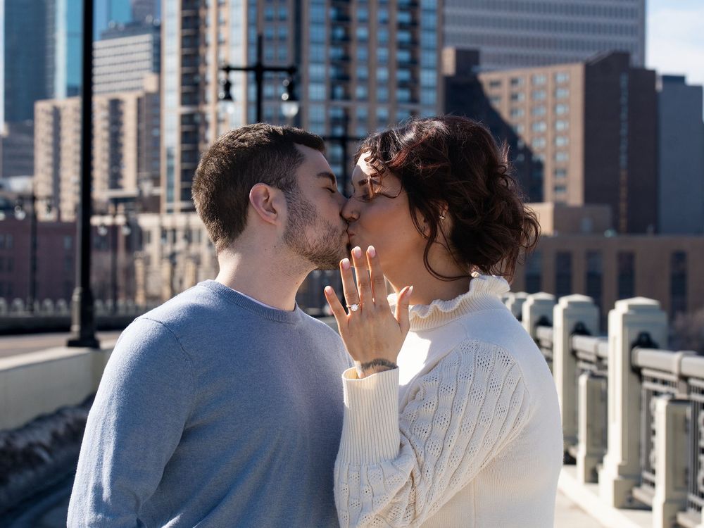 Couple kissing after the proposal, ring on show